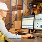 warehouse worker using computer for warehouse management