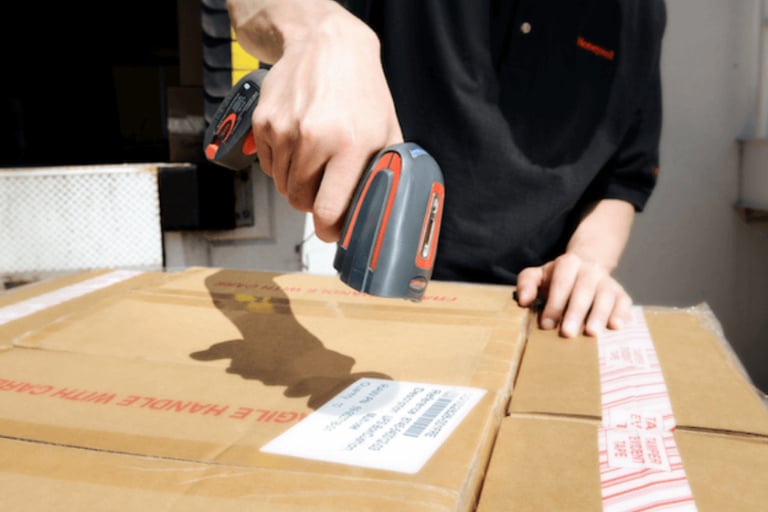 barcode scanner being used on a box